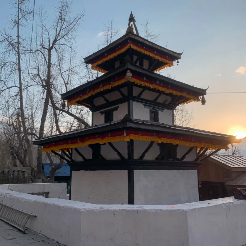 Traditional three-tiered pagoda style Muktinath Temple at sunrise during Jomsom Muktinath Ghorepani Poon Hill Trek Mustang Nepal.